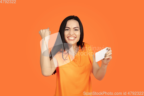 Image of Caucasian young woman\'s portrait on orange background