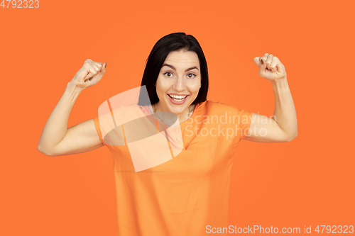 Image of Caucasian young woman\'s portrait on orange background