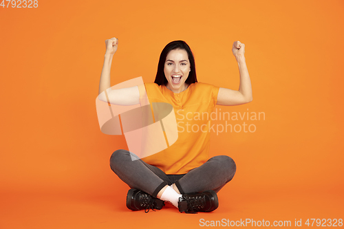 Image of Caucasian young woman\'s portrait on orange background