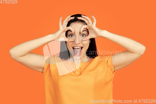 Image of Caucasian young woman\'s portrait on orange background