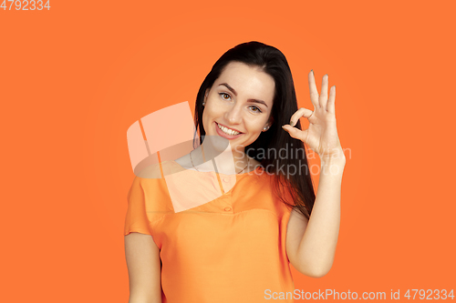 Image of Caucasian young woman\'s portrait on orange background