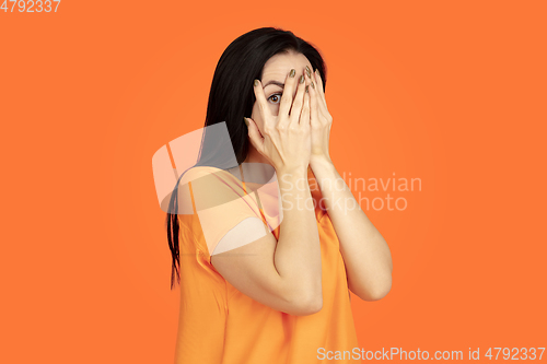 Image of Caucasian young woman\'s portrait on orange background