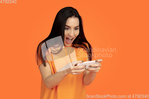 Image of Caucasian young woman\'s portrait on orange background