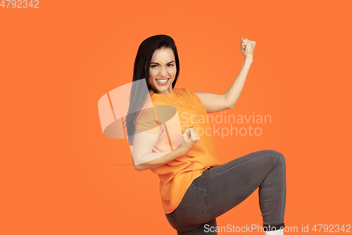 Image of Caucasian young woman\'s portrait on orange background