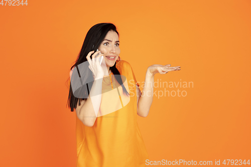 Image of Caucasian young woman\'s portrait on orange background