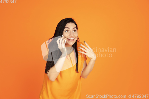 Image of Caucasian young woman\'s portrait on orange background