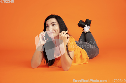 Image of Caucasian young woman\'s portrait on orange background