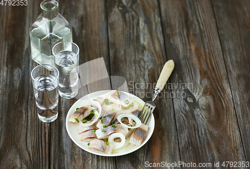 Image of Vodka and traditional snack on wooden background