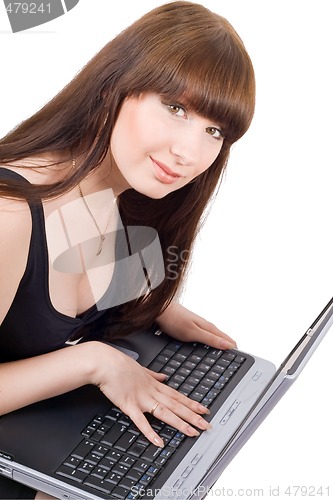 Image of The young businesswoman sits with the laptop. Isolated