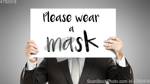 Image of business man message Please wear a mask
