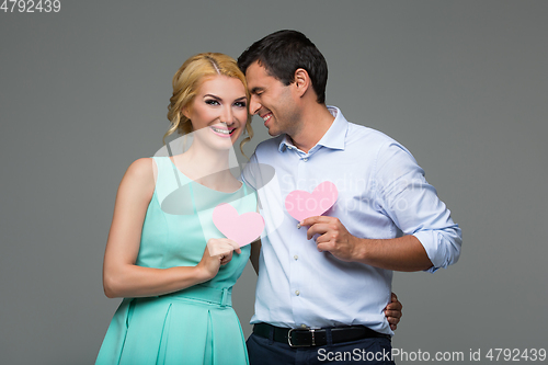 Image of Beautiful couple holding pink hearts
