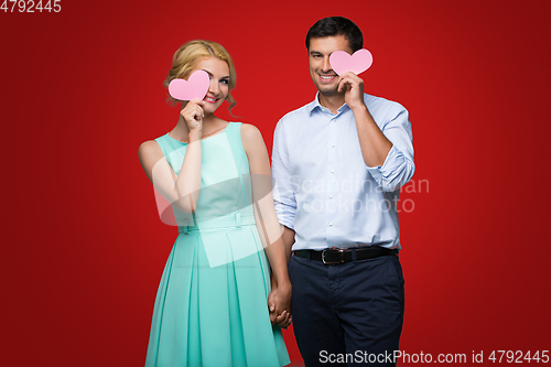 Image of Beautiful couple holding pink hearts