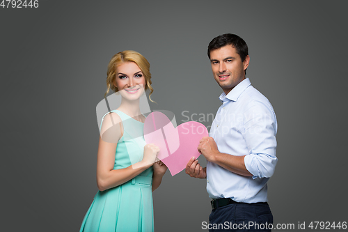 Image of Beautiful couple holding pink heart