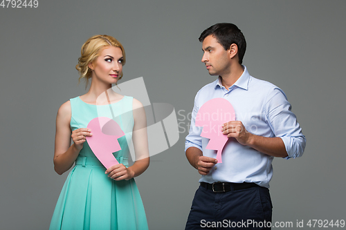 Image of Beautiful couple holding pink broken heart