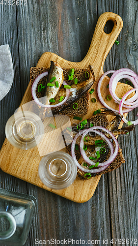 Image of Vodka and traditional snack on wooden background