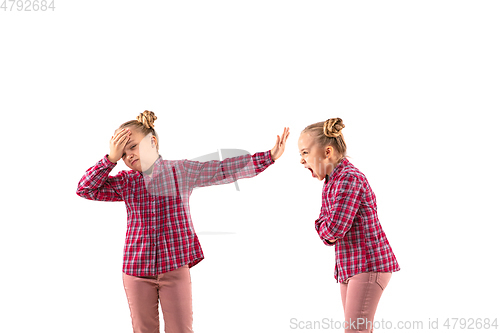 Image of Young handsome girl arguing with herself on white studio background.