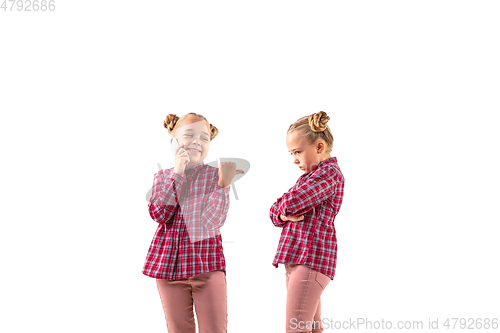 Image of Young handsome girl arguing with herself on white studio background.