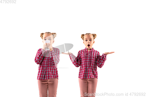 Image of Young handsome girl arguing with herself on white studio background.