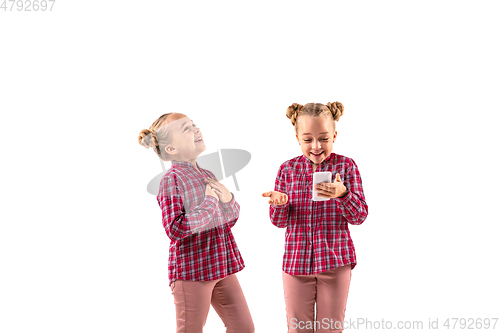 Image of Young handsome girl arguing with herself on white studio background.