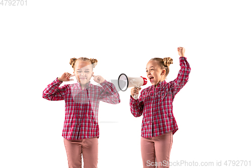 Image of Young handsome girl arguing with herself on white studio background.