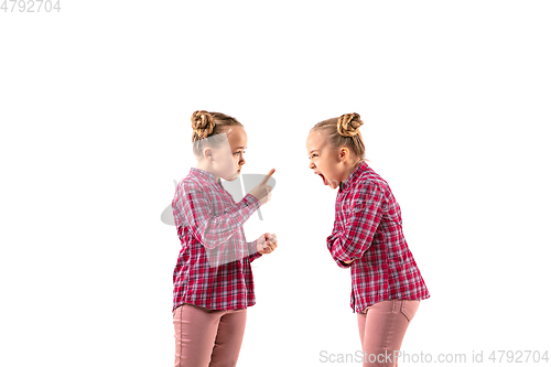 Image of Young handsome girl arguing with herself on white studio background.