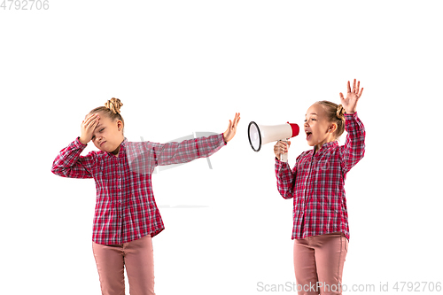 Image of Young handsome girl arguing with herself on white studio background.