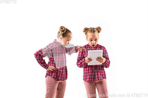 Image of Young handsome girl arguing with herself on white studio background.