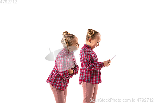 Image of Young handsome girl arguing with herself on white studio background.