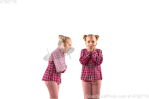 Image of Young handsome girl arguing with herself on white studio background.