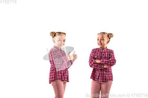 Image of Young handsome girl arguing with herself on white studio background.