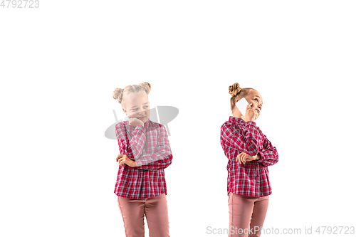 Image of Young handsome girl arguing with herself on white studio background.