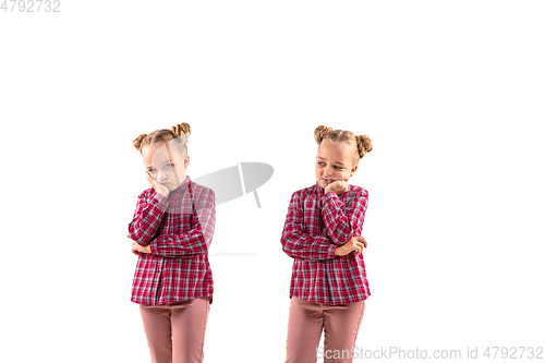 Image of Young handsome girl arguing with herself on white studio background.