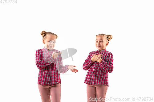 Image of Young handsome girl arguing with herself on white studio background.