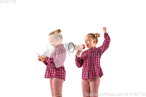 Image of Young handsome girl arguing with herself on white studio background.