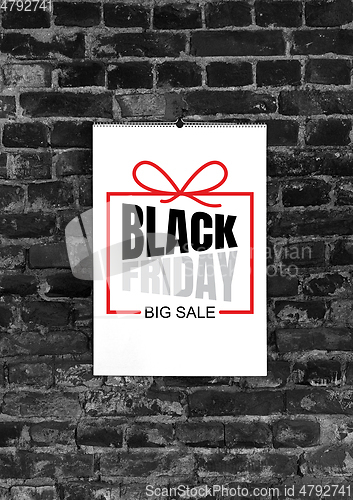 Image of Black friday ad on black brick background