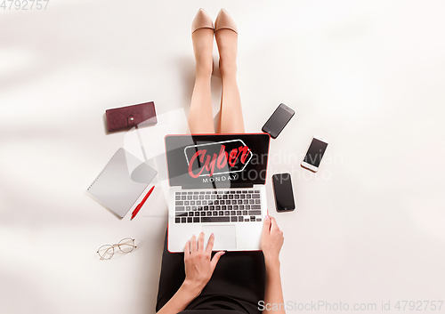 Image of Top view of gadgets with cyber monday lettering on white background