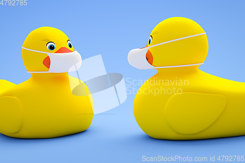 Image of two toy ducky wearing a mask
