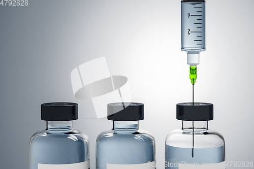 Image of A syringe and three bottles of medicine