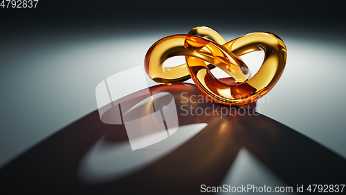 Image of golden glass knot with light reflections