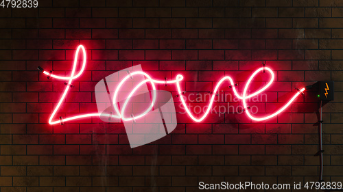 Image of Love sign neon letters at a brick wall