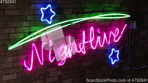 Image of neon light sign nightlive with stars