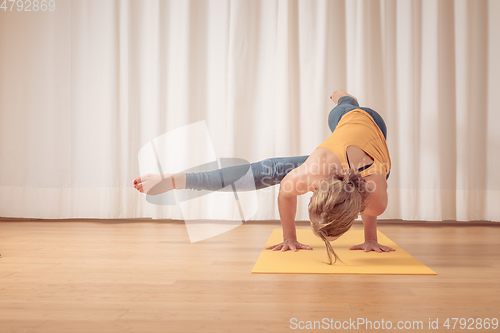 Image of two women doing yoga at home