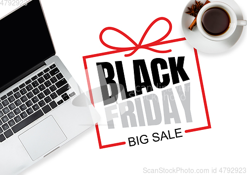 Image of Top view of laptop and cup of tea with black friday lettering on white background