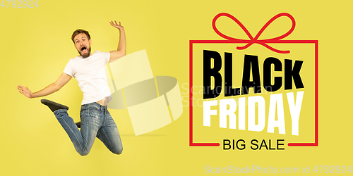 Image of Portrait of young man on yellow background with black friday lettering