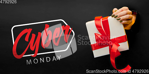 Image of Hands holding gift box with black friday lettering