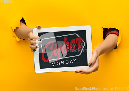 Image of Hands holding tablet screen with black friday lettering