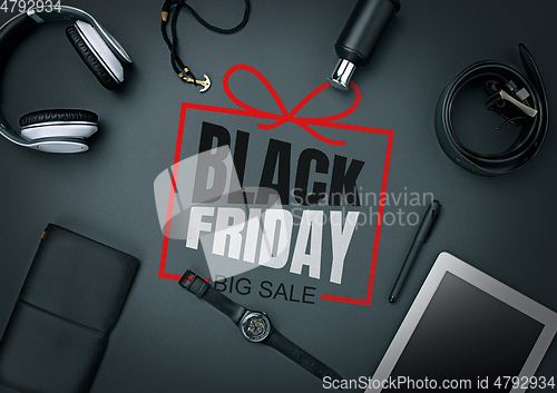 Image of Top view of gadgets with black friday lettering on black background