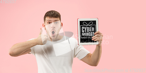 Image of Portrait of young man showing tablet screen, black friday