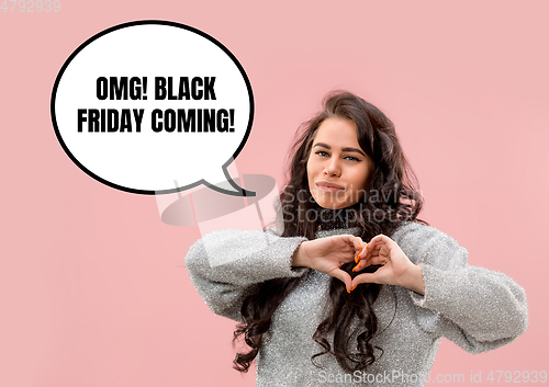 Image of Portrait of woman showing the sign of heart black friday