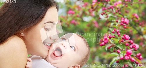 Image of mother with baby over spring garden background